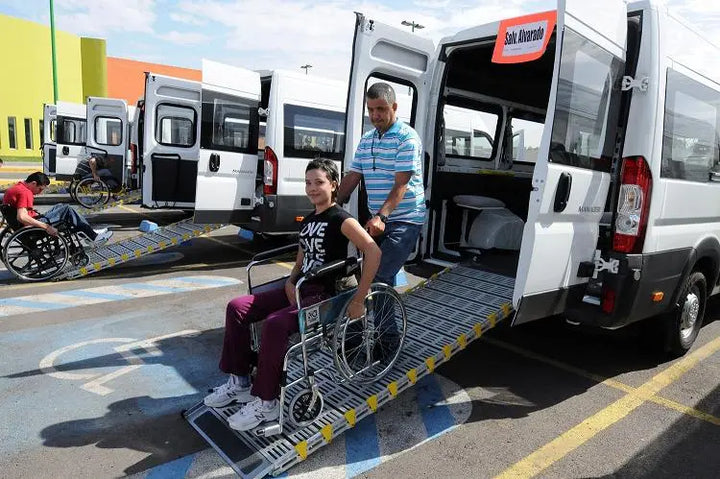 roll-a-ramp portable aluminum wheelchair ramp at reliable ramps being used to roll a patient out the back of a vehicle.