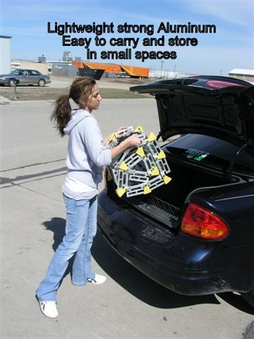 roll-a-ramp portable aluminum wheelchair ramp at reliable ramps being put away in a trunk by a lady