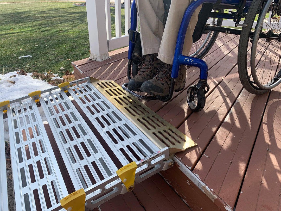 roll-a-ramp portable aluminum wheelchair ramp at reliable ramps closeup of man at top of ramp in a blue wheelchair