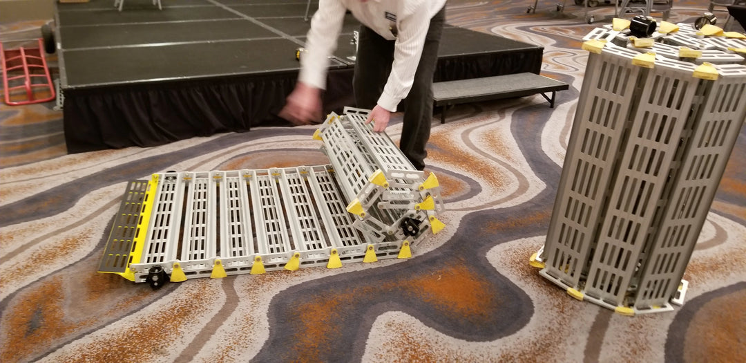 roll-a-ramp portable aluminum wheelchair ramp at reliable ramps being rolled up by someone in front of a stage