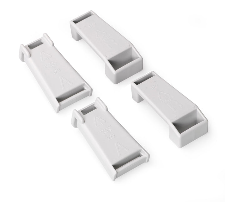 Four white rectangular plastic components on a white background