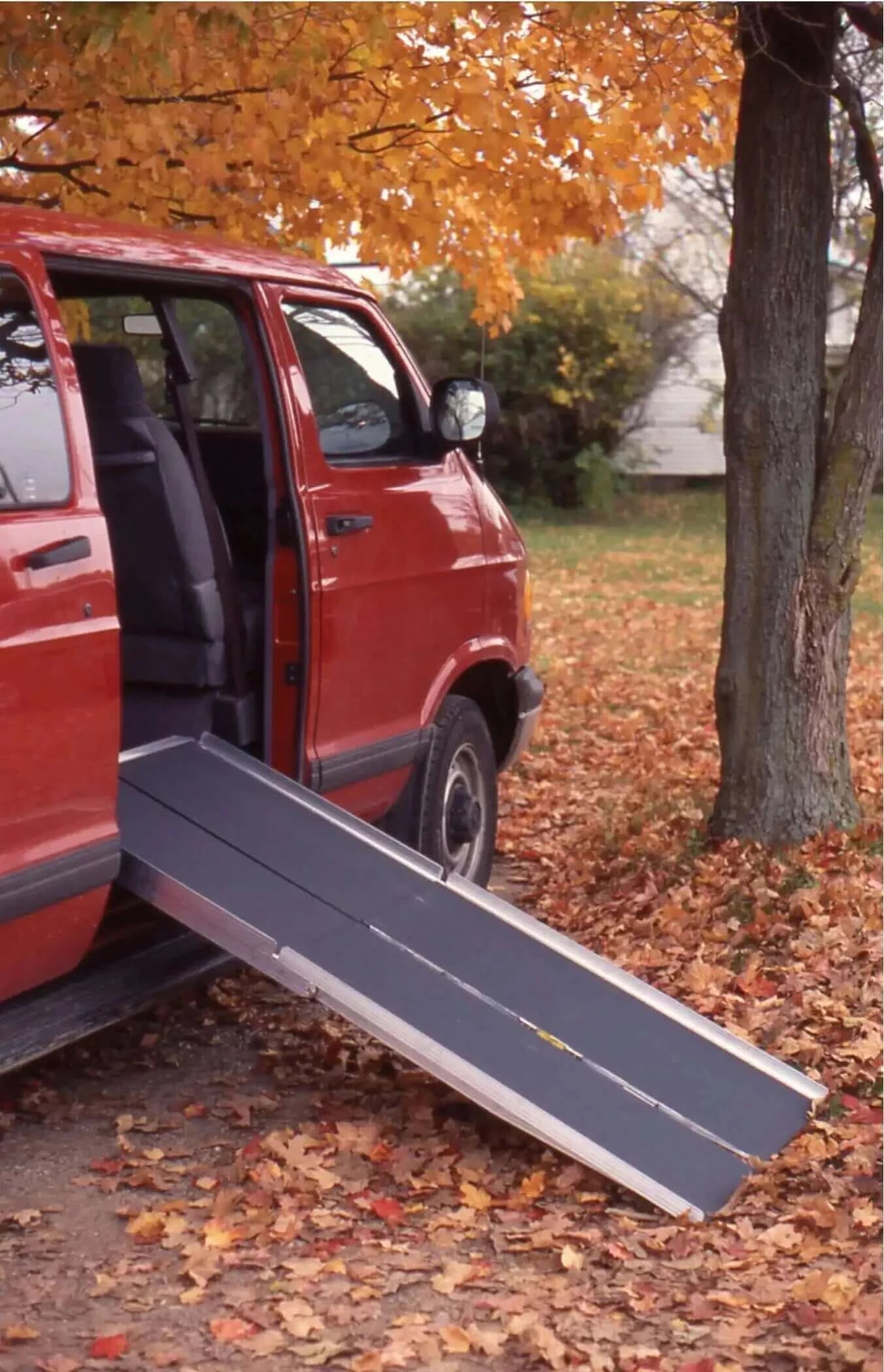 alumilite ready folding ramp being used with a red van