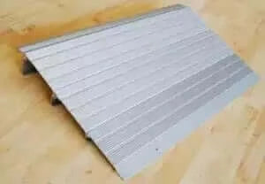 American Access - Hero Aluminum Threshold Ramp for Wheelchairs - ramp sitting on a wooden floor