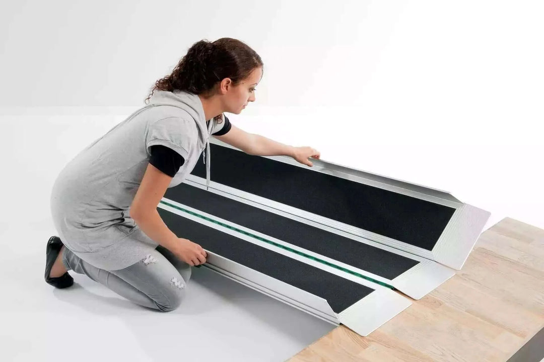 Guldmann - Stepless EasyFold Pro3 Portable Wheelchair Ramp being setup by a lady on the ground
