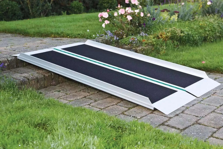 Guldmann - Stepless EasyFold Pro Portable Wheelchair Ramp unfolded and laid out over one step.