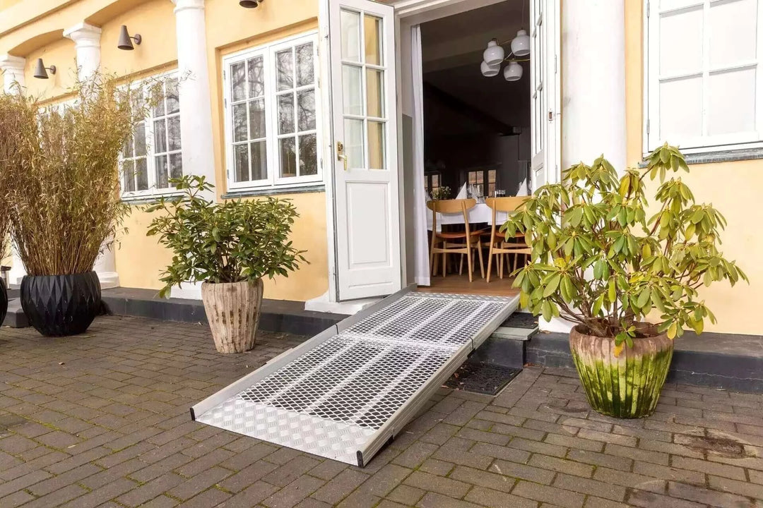 Guldmann - Stepless Wide Folding Pro Portable Wheelchair Ramp setup outside a home