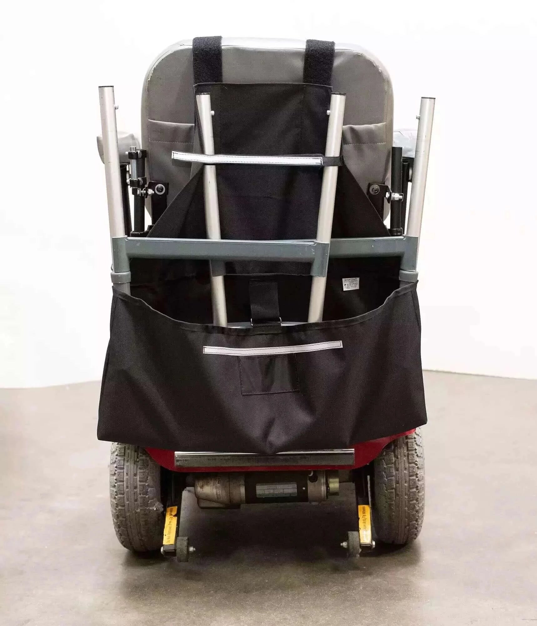 back view of a motorized scooter with a walker holder on the back of it