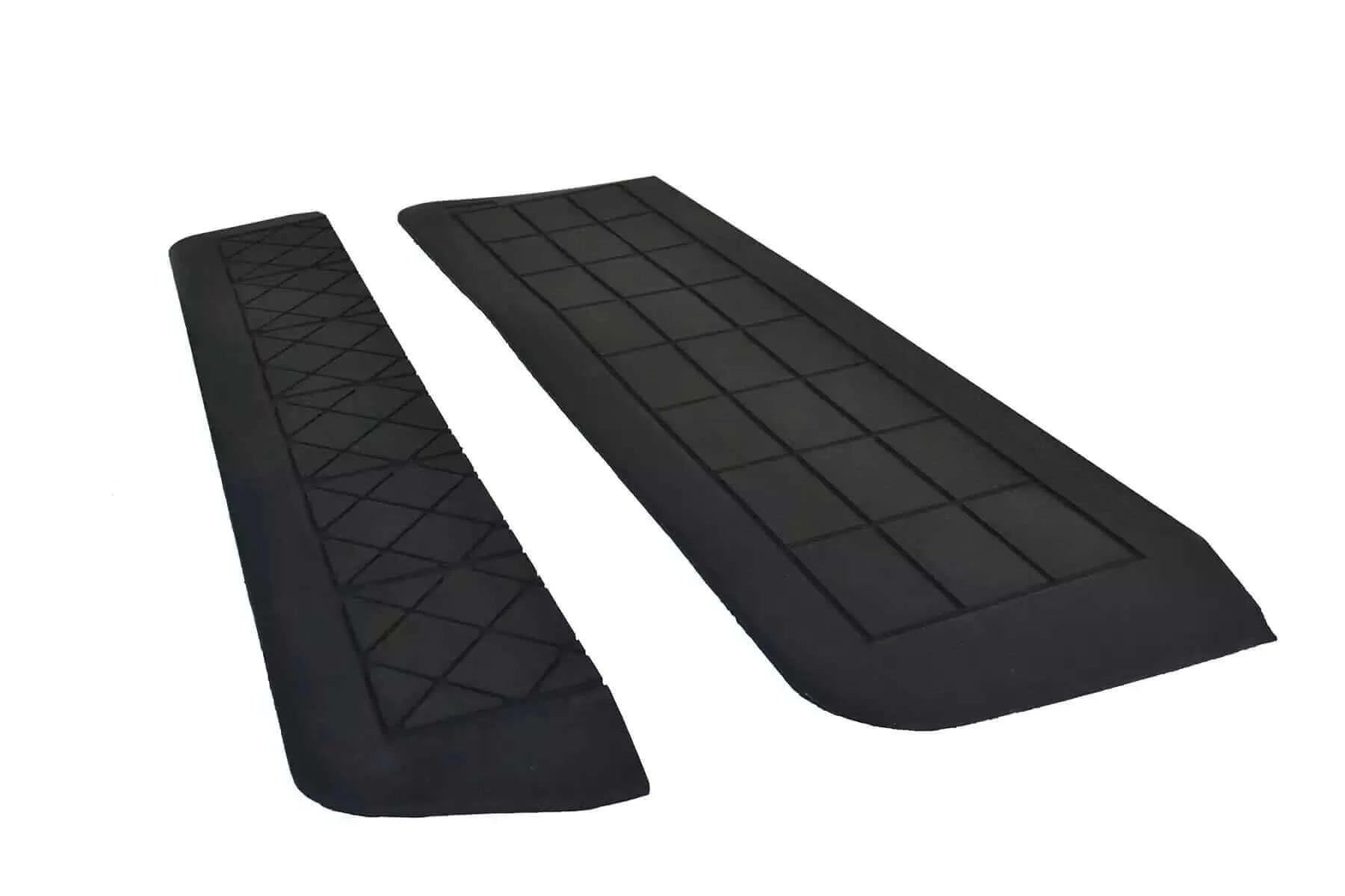 two rubber threshold ramps with a white background