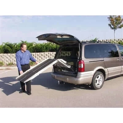 PVI - Multi-Fold Rear Door Mountable Van Wheelchair Ramp being folded into a van by a user