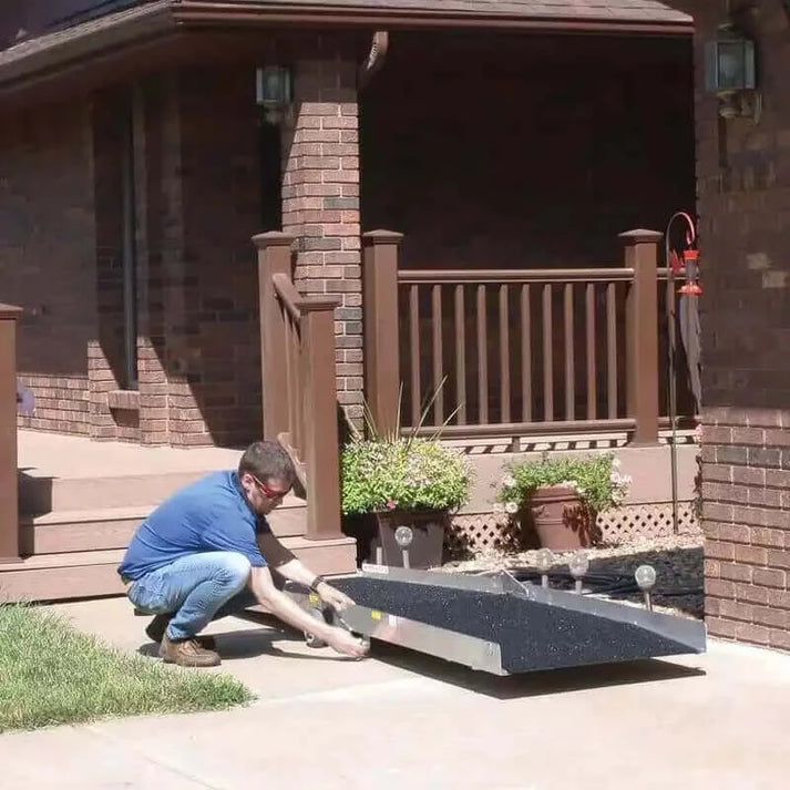 man setting up pvi wheel-a-bout ramp at his house