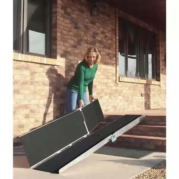 lady unfolding a multi fold portable pvi ramp to go up 3 steps