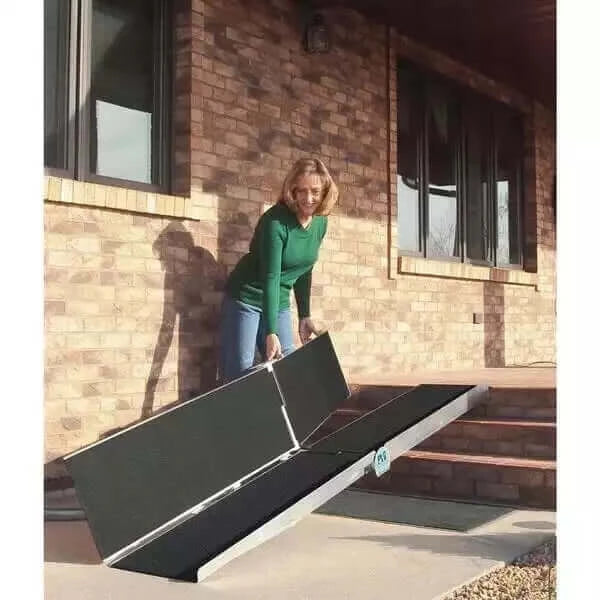 PVI - Aluminum Multi-Fold Portable Wheelchair Ramp being shown with a lady who's folding it up