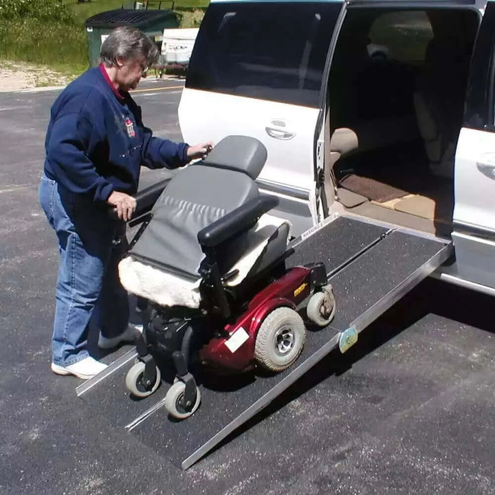 PVI - Aluminum Multi-Fold Portable Wheelchair Ramp being shown with someone using it with their vehicle