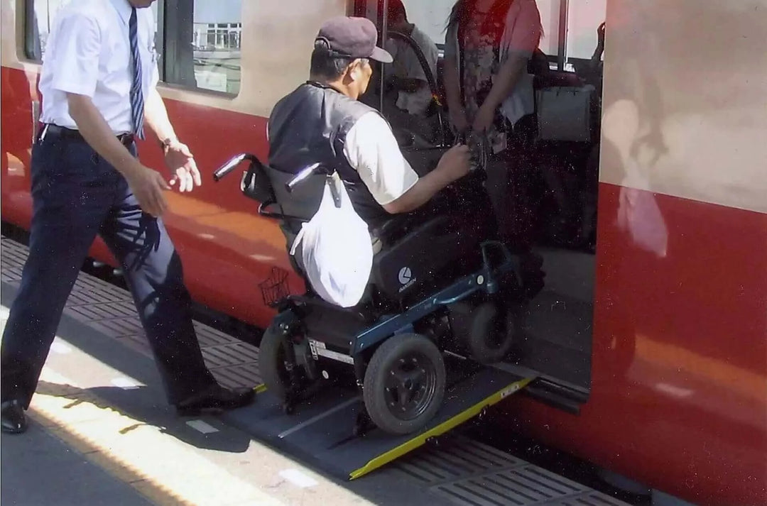 Guldmann - Stepless Single Folding Lite Wheelchair Ramp being used outside by a patient