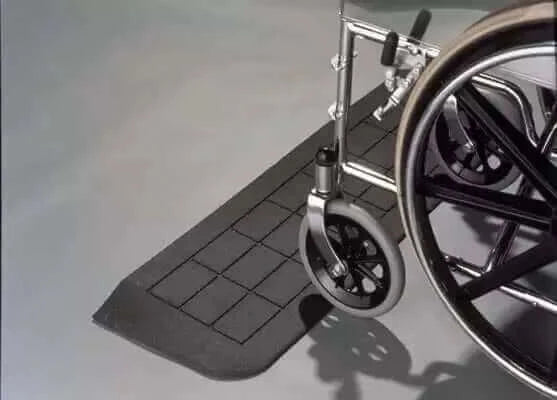 PVI rubber threshold ramp being traversed by a wheelchair