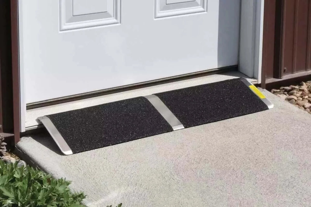 PVI - Aluminum Solid Bariatric Threshold Ramp for Wheelchairs sitting in front of a door outside