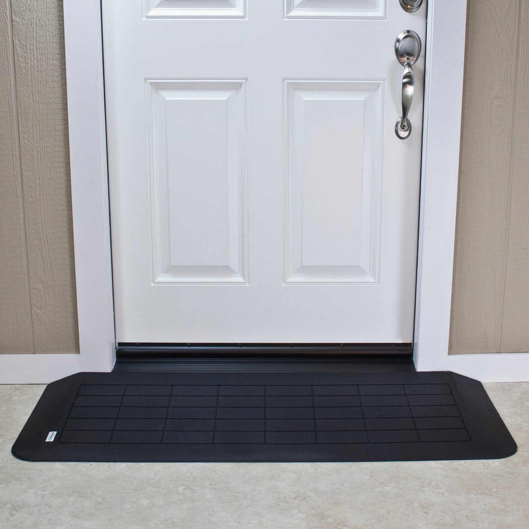 AlumiRamp Rubber Threshold Ramp for Wheelchairs - in front of a white door
